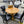 Round Oak Pedestal Dining Table with Leaf & 4 Black Faux Leather Chairs